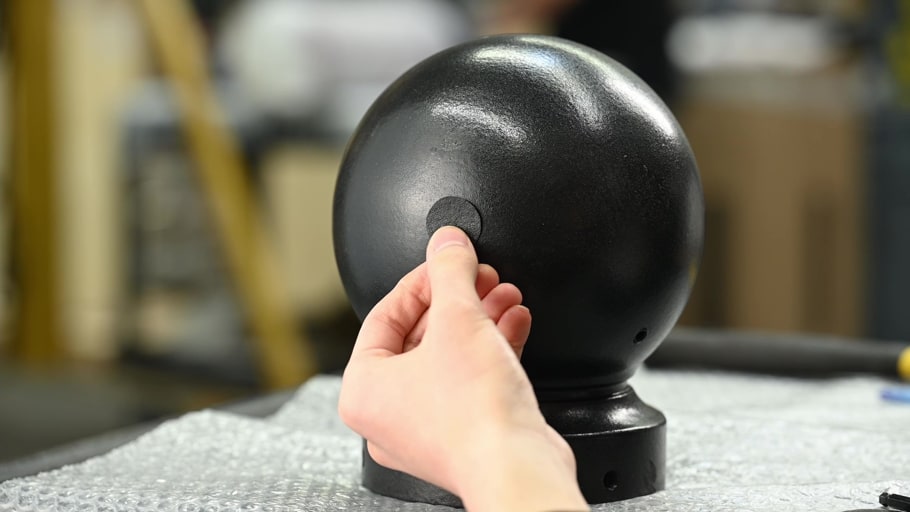 A thermoplastic patch being applied onto an Ironarmor-coated bollard cap.