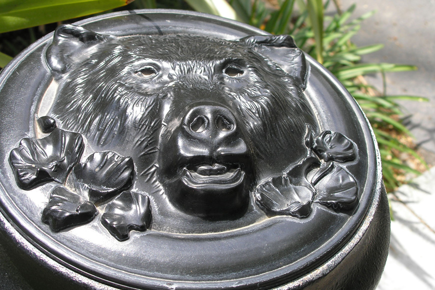 The top of a bollard is customized with a bear’s head and flowers