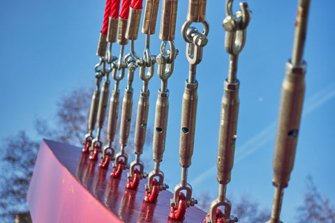 line of steel turnbuckles with jaw end fittings used to hold up a steel beam of an architecture