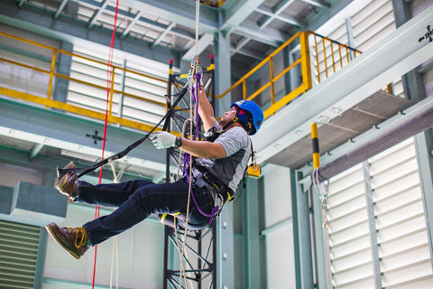 worker in descent and rescue equipment for fall protection